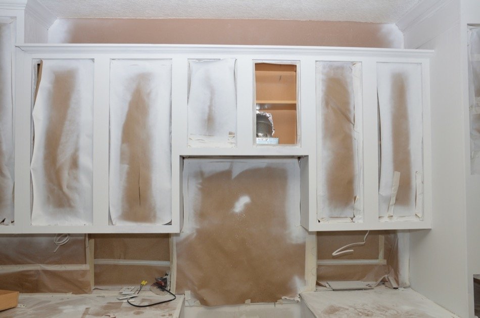 Cabinet repainting preparation with doors masked for finishing