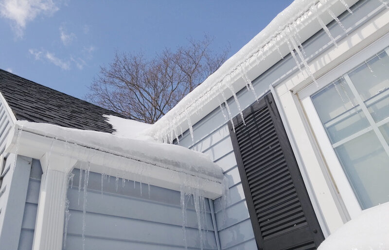 Ice buildup and icicles along a roof edge