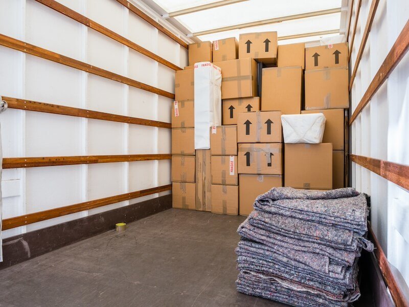 Moving truck loaded with boxes and protective blankets